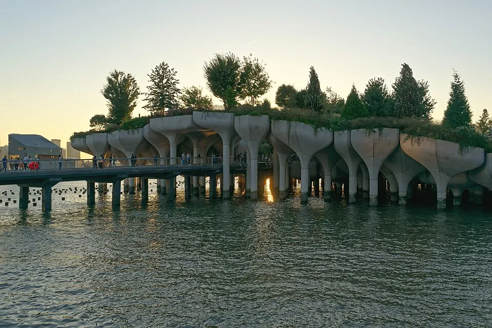Little Island's tulip-shaped piles and trees over the Hudson River at golden hour