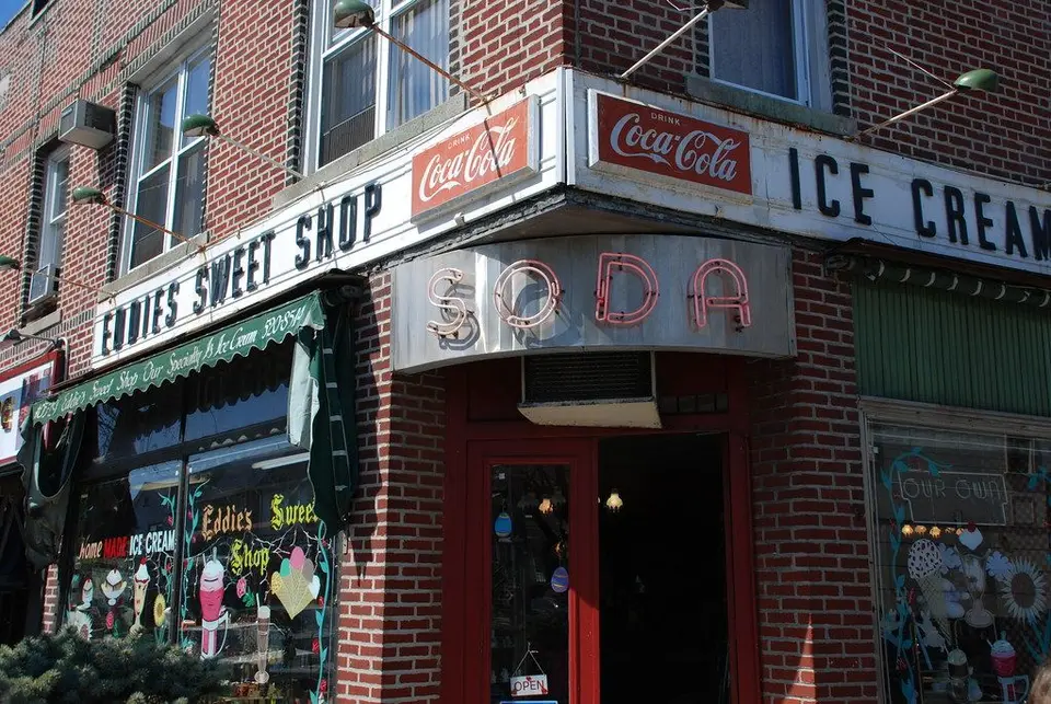 Eddie's Sweet Shop corner storefront with Ice Cream and Soda signs