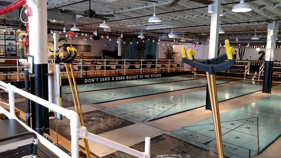 Rows of shuffleboard courts inside the Royal Palms hall